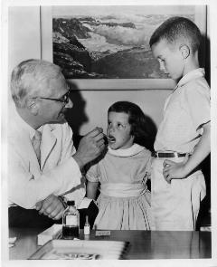 Sabin vaccinating two children