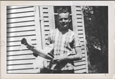 Childhood photo of Neil Armstrong with model airplane.