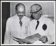 Image of WA and colleague looking at Annals of Surgery 